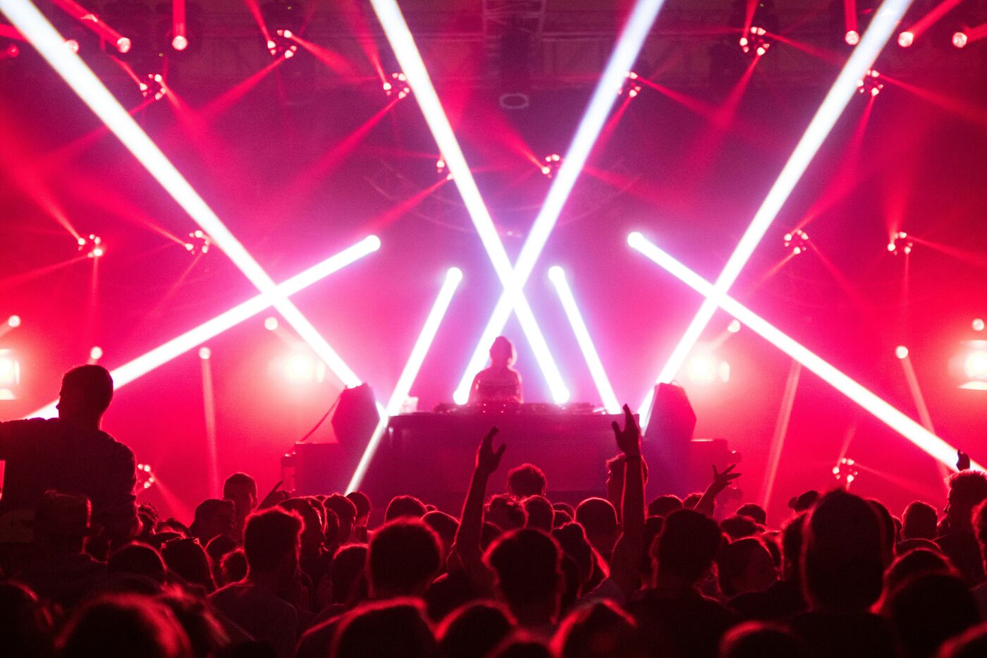 DJ silhouette with a crowd and laser lights